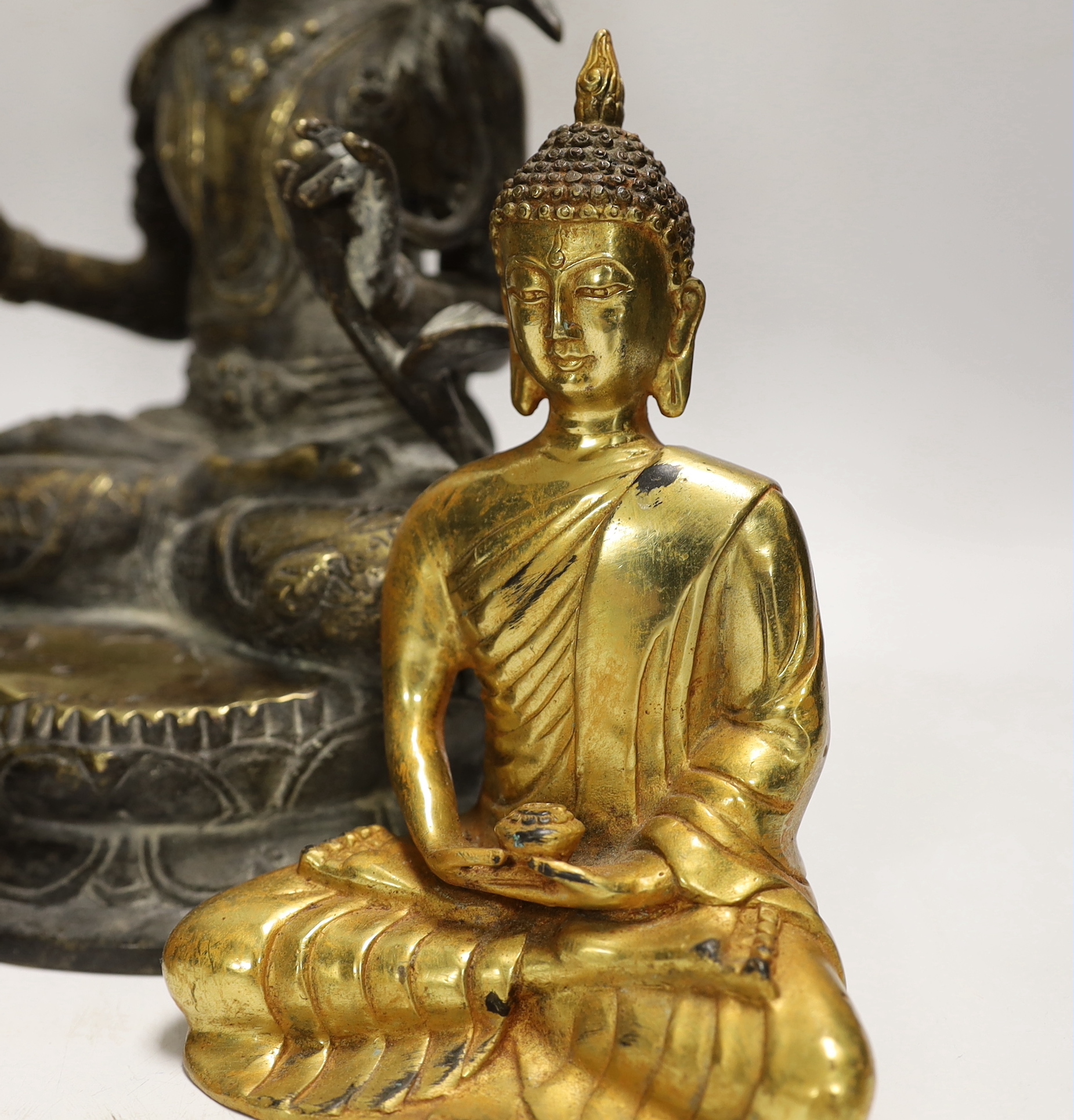 Four Thai and far-eastern bronze figures of the Buddha, tallest 28cm